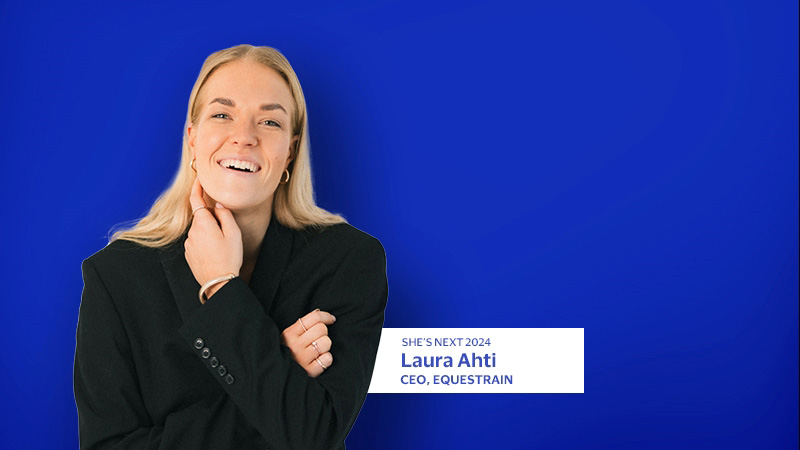 Laura Ahti smiling with blue background